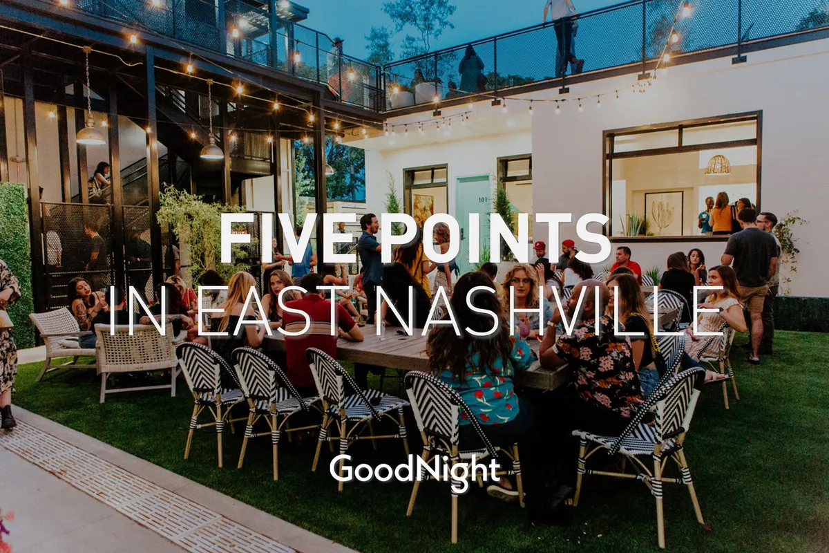 An inviting exterior image showcasing a large gathering table set beneath string lights, with people socializing in a modern architectural setting. The warm lighting and group activities evoke a festive yet intimate atmosphere, perfect for evening gatherings or casual cocktails under the stars.