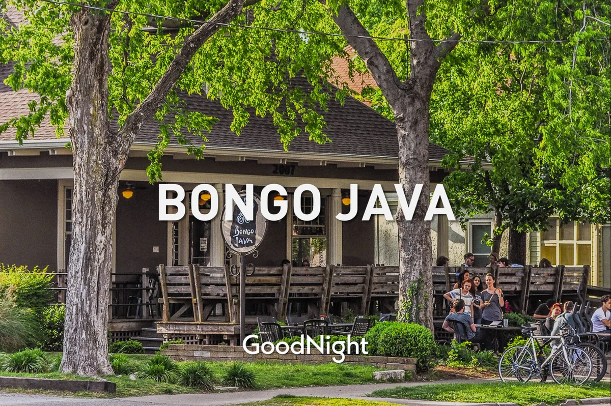 This image captures the exterior of Bongo Java, a beloved neighborhood coffee shop. The scene is lively, with people enjoying drinks at outdoor tables, bicycles parked nearby, and the prominent Bongo Java sign setting the local vibe. The overall mood is communal, relaxed, and distinctly local.