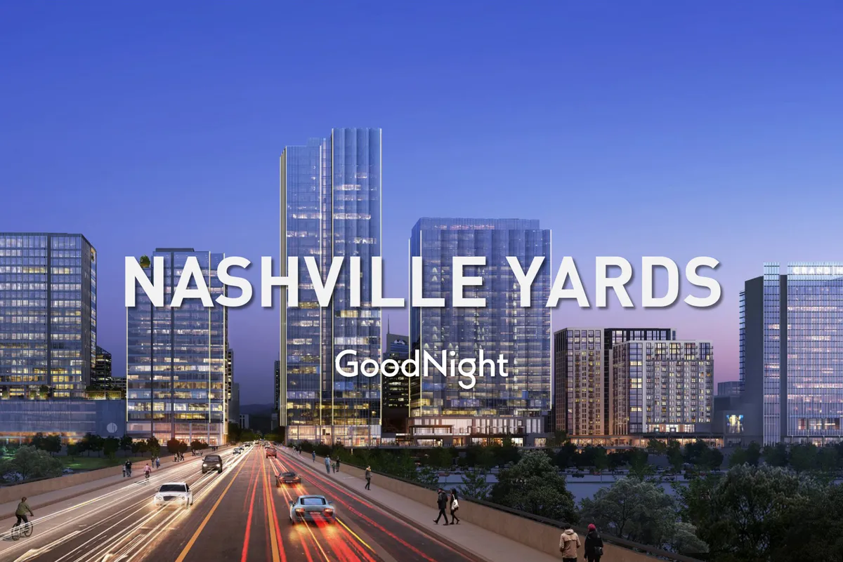 A vibrant downtown Nashville street scene with tall glass skyscrapers, busy traffic, and people walking on the sidewalks. The image highlights the city’s urban energy and accessibility to offices, dining, and nightlife.